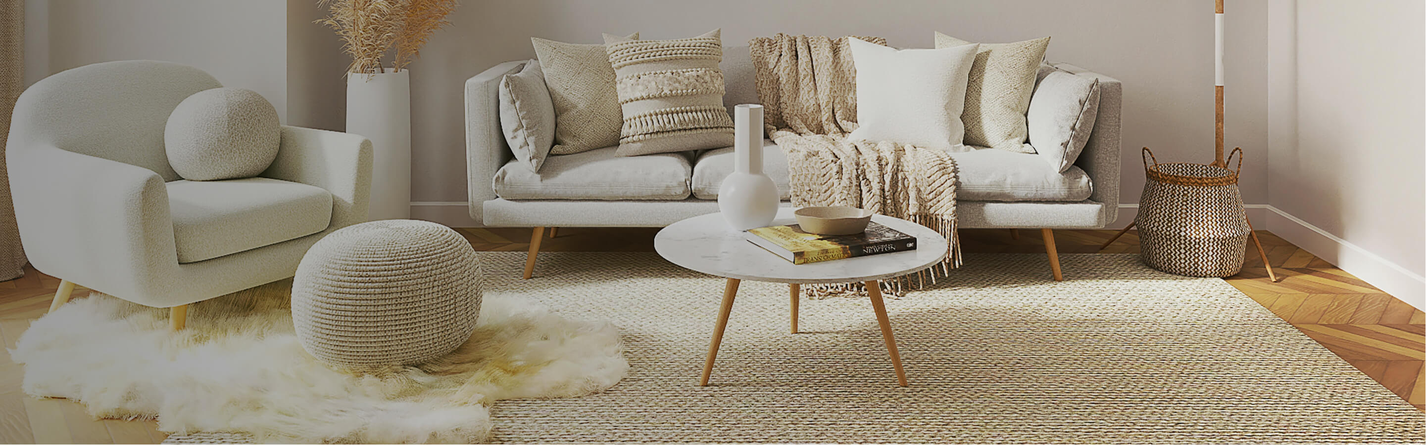 Cream colored living rom with area rug, light floors