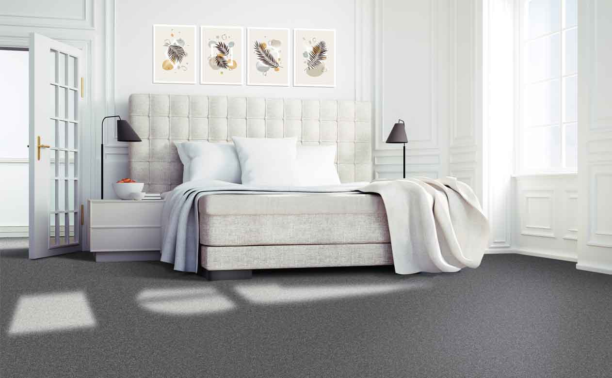 Bedroom with dark grey carpet and cream fabric bedframe