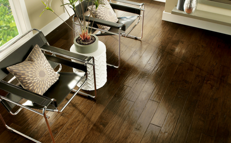 Dark hardwood classic floors with brown metal chairs.